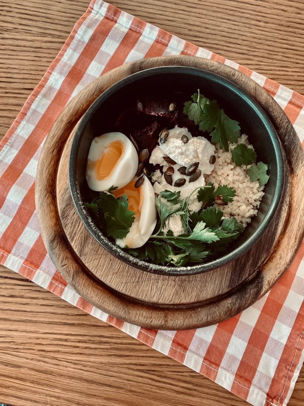 Balanced meal bowl with eggs, couscous and greens